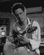 Lindsey in his studio playing the guitar
